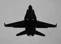 Silhouette of F-18 Blue Angel as he flies directly overhead